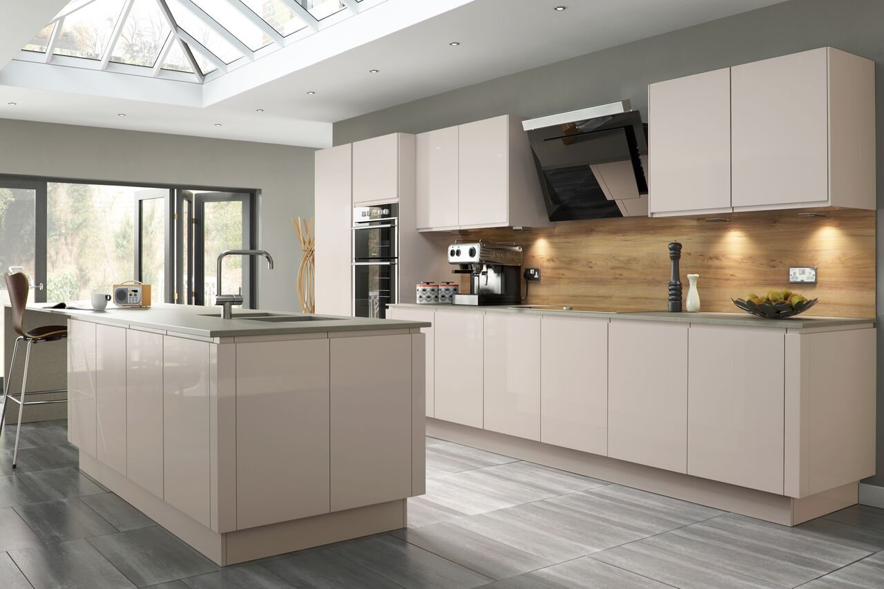 A white kitchen with solid timber worktops and a window above the sink